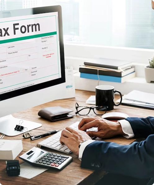 Tax form on computer screen at a desk