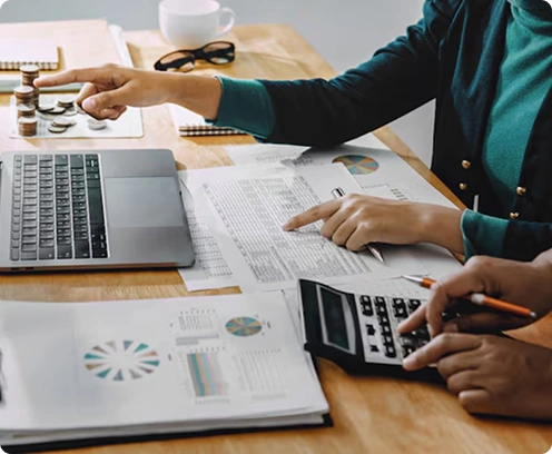 Bookkeeper working with calculator and laptop