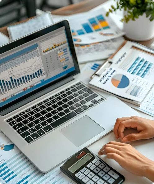 Laptop with financial charts on desk