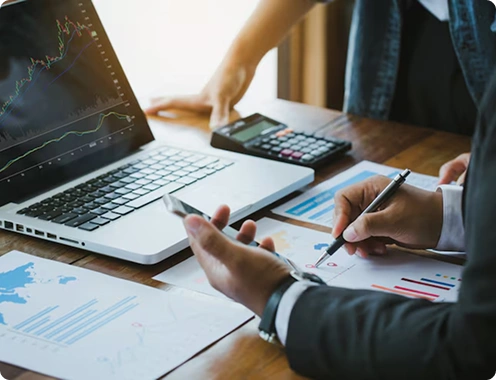 Professionals reviewing financial documents at desk