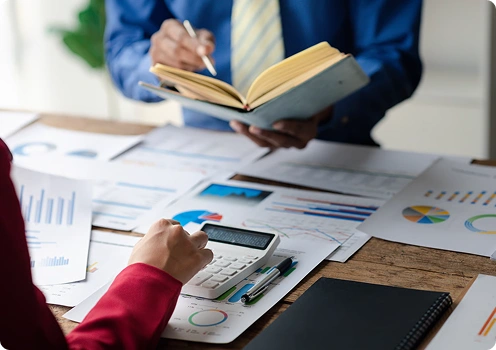 Desk with tax form on monitor and calculator